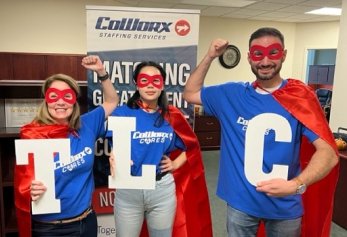 CoWorx employees in superhero costumes holding TLC sign