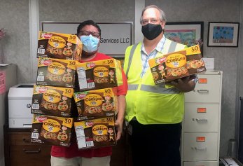 CoWorx workers holding boxes of cookies