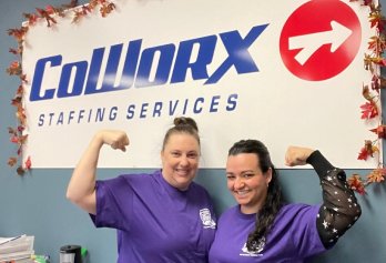 Two CoWorx employees smiling, flexing muscles for camera
